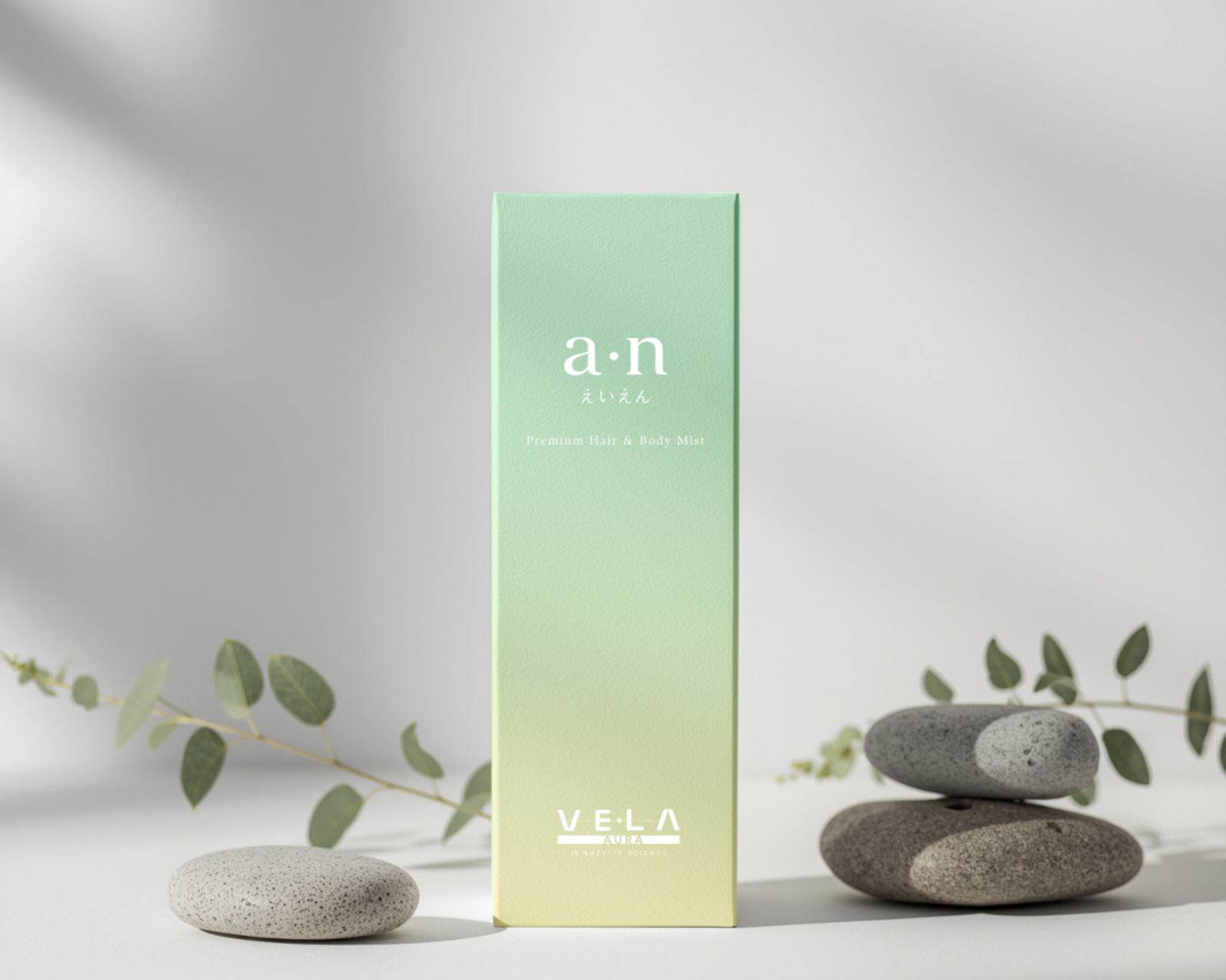 VE•LA a·n box in a mint-to-lemon gradient, between stones